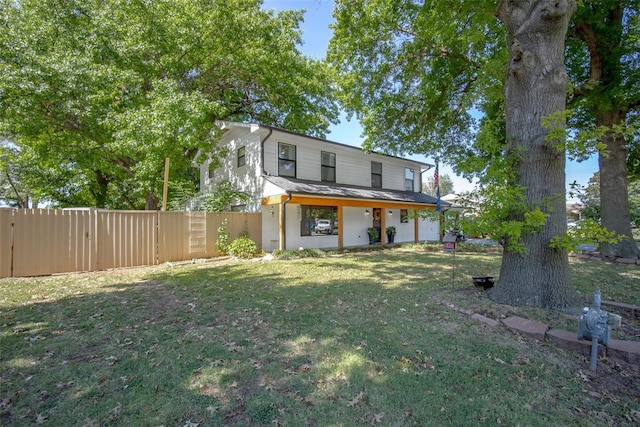 rear view of property with a lawn