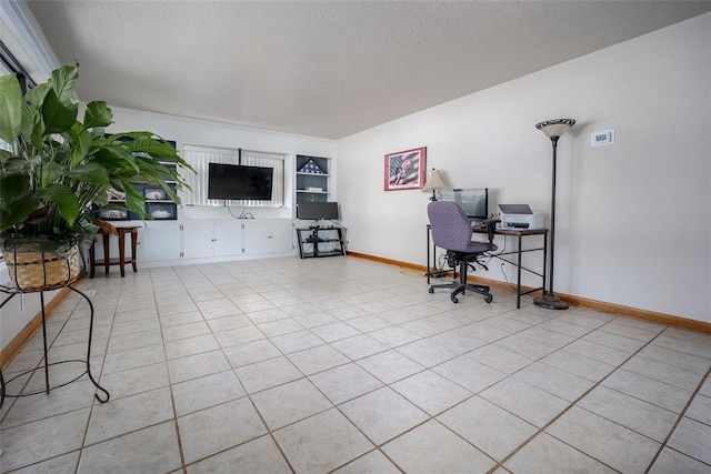 office featuring light tile patterned floors and a textured ceiling