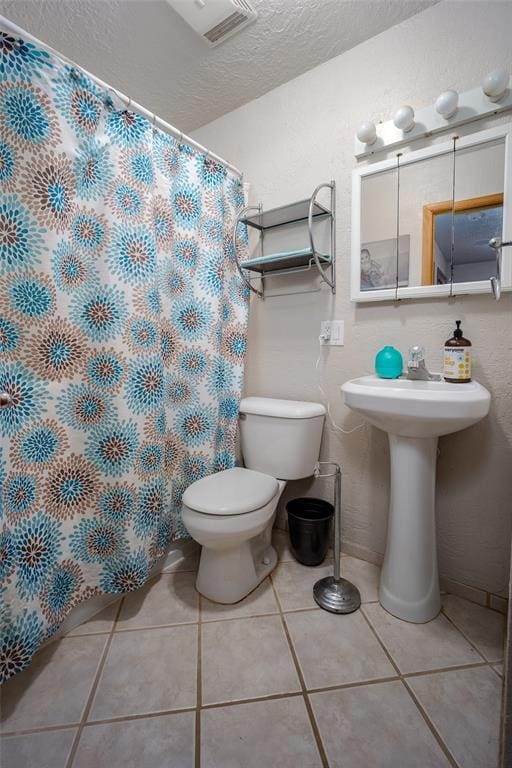 bathroom featuring tile patterned flooring and toilet