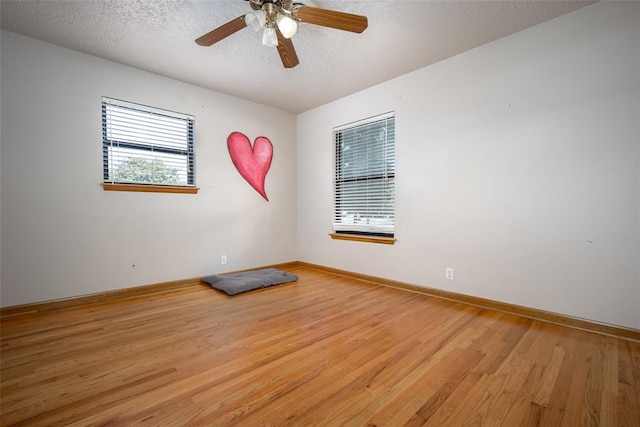 unfurnished room featuring ceiling fan, a textured ceiling, and light hardwood / wood-style flooring