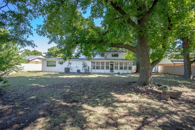 back of property featuring a sunroom and central AC unit