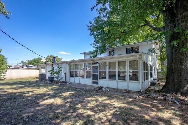 rear view of property featuring a sunroom