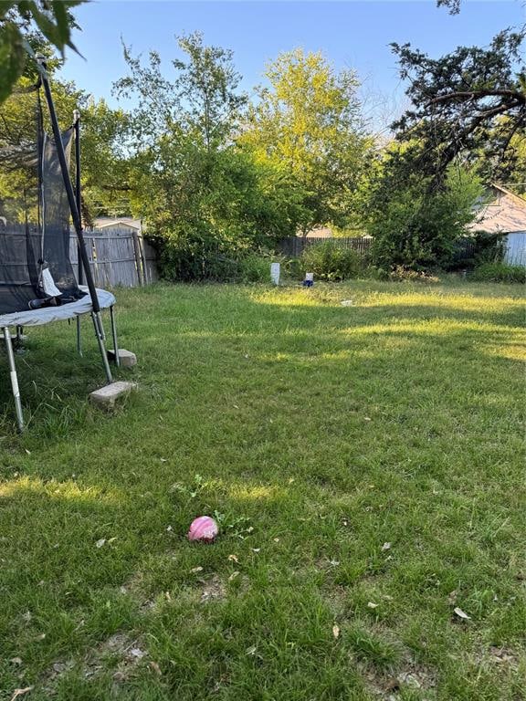 view of yard with a trampoline