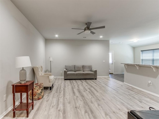 living room with ceiling fan and light hardwood / wood-style floors