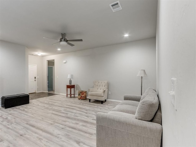 living room with ceiling fan and light wood-type flooring