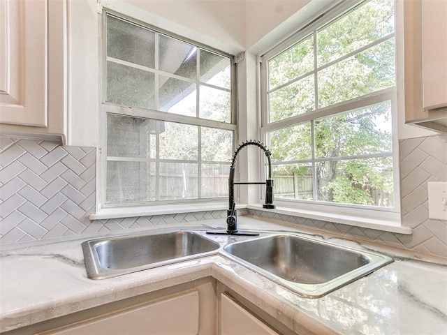 kitchen with sink and tasteful backsplash