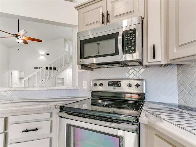 kitchen with backsplash, ceiling fan, and stainless steel appliances