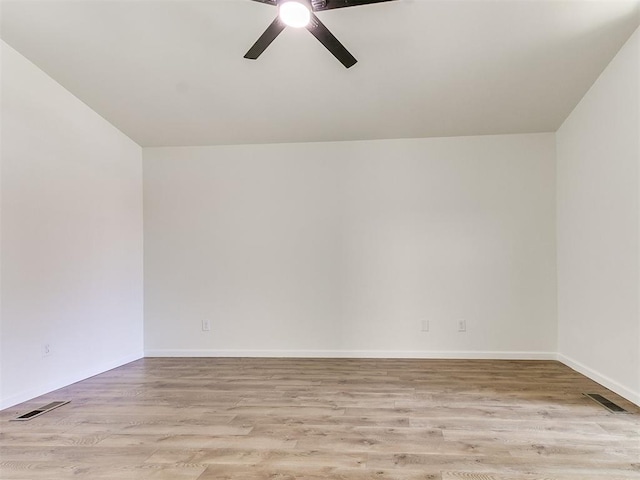 empty room featuring ceiling fan and light hardwood / wood-style flooring