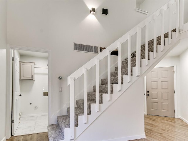 staircase with hardwood / wood-style flooring