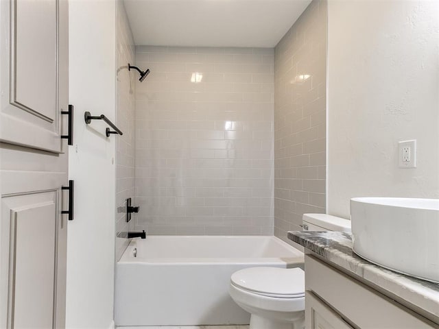 full bathroom featuring vanity, toilet, and tiled shower / bath combo