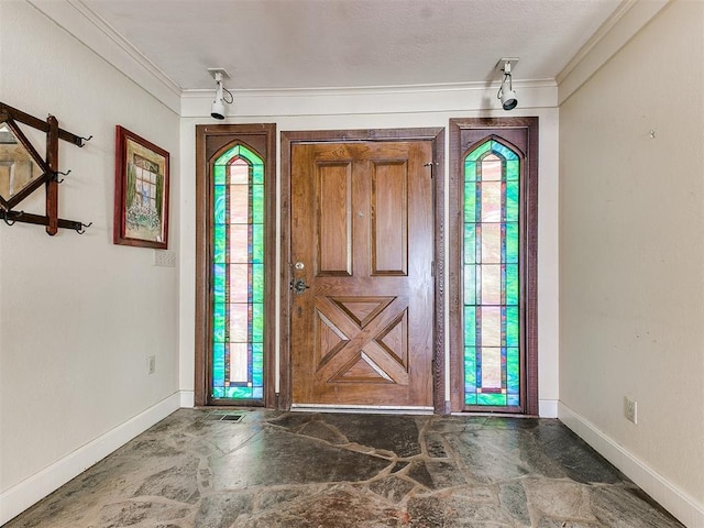 foyer featuring ornamental molding