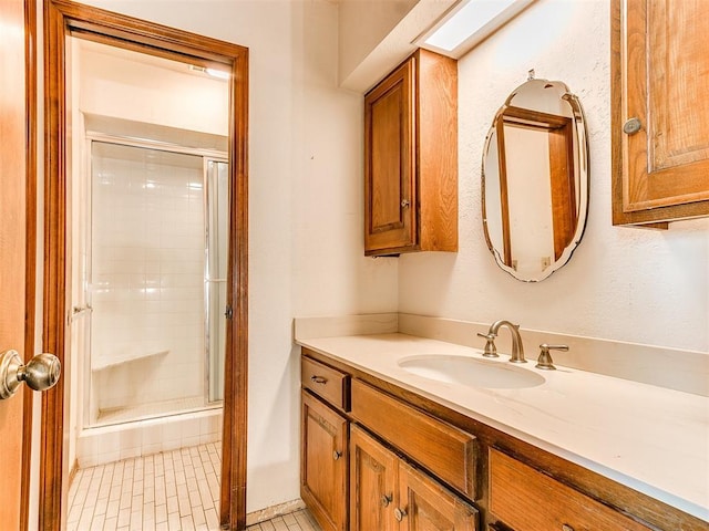 bathroom with tile patterned floors, vanity, and a shower with shower door