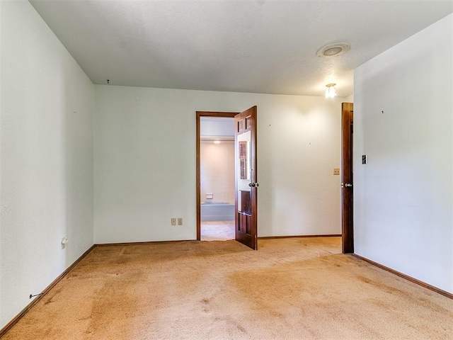 spare room with light colored carpet