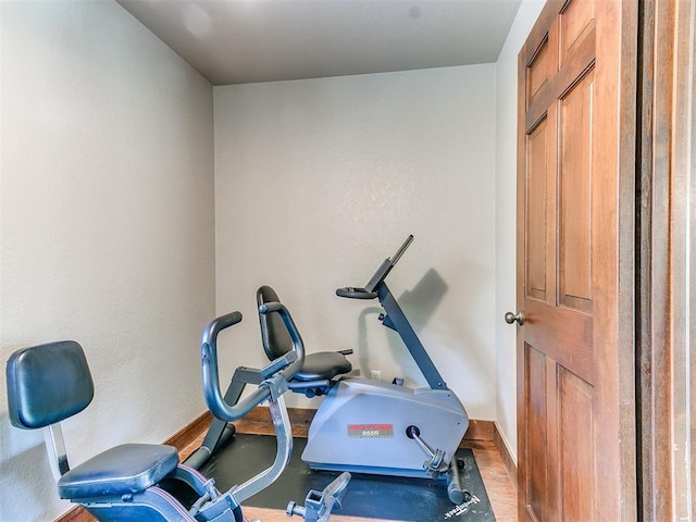 workout area with wood-type flooring