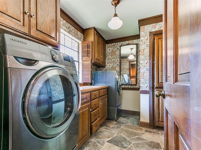 laundry room with cabinets, crown molding, and washer / clothes dryer