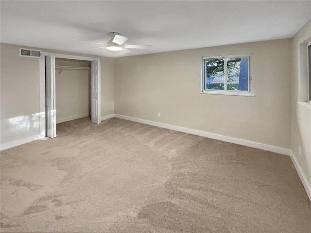 unfurnished bedroom with carpet flooring, ceiling fan, and a closet