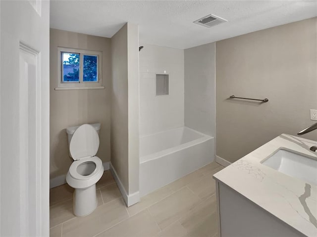 full bathroom featuring tile patterned flooring, a textured ceiling, toilet, vanity, and bathtub / shower combination