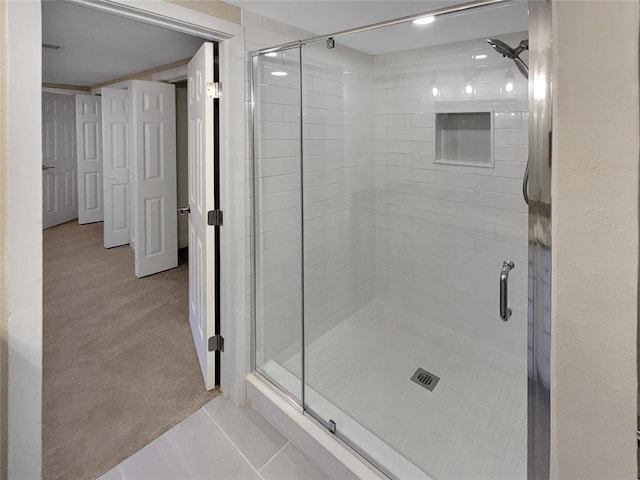 bathroom featuring a shower with shower door