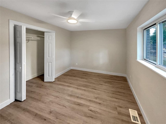 unfurnished bedroom with ceiling fan, a closet, and light hardwood / wood-style floors