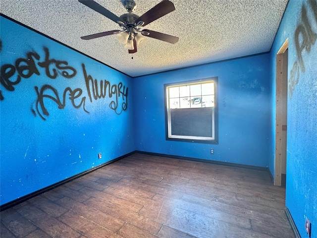 spare room with hardwood / wood-style floors, ceiling fan, and a textured ceiling