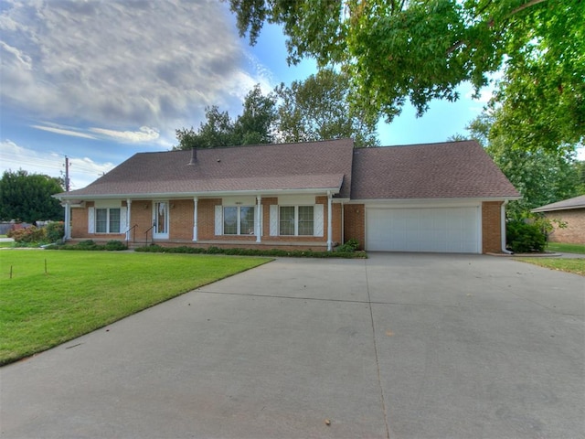 single story home featuring a garage and a front lawn