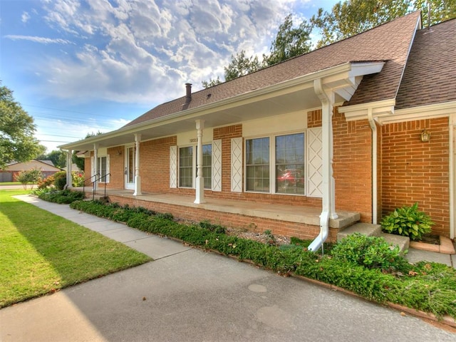 view of home's exterior with a lawn and a porch