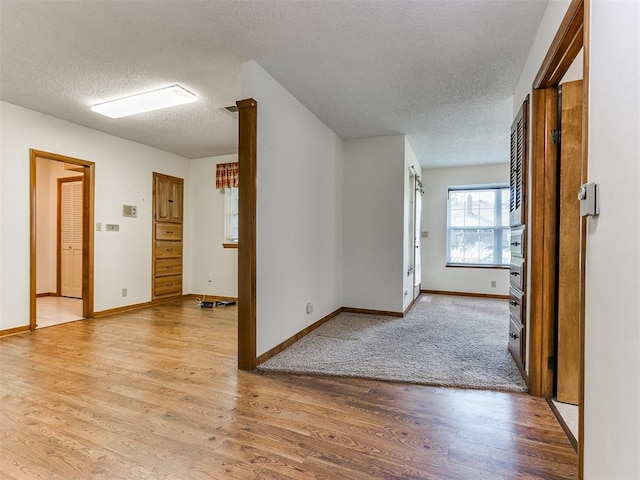 interior space featuring light hardwood / wood-style floors and a textured ceiling