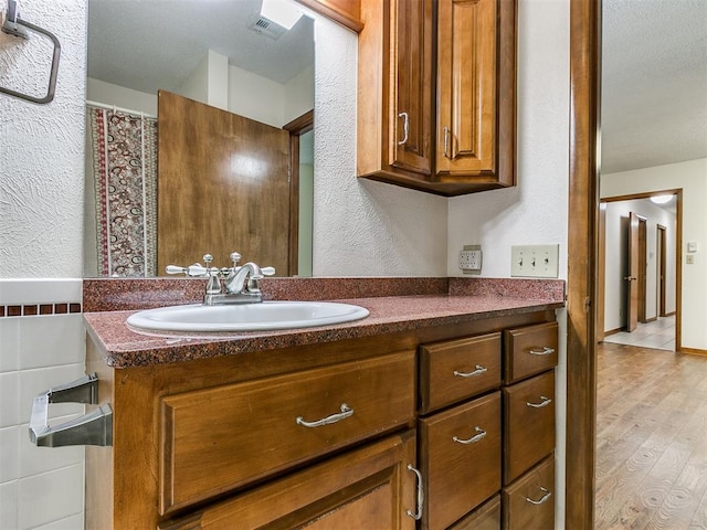 bathroom featuring vanity and wood-type flooring