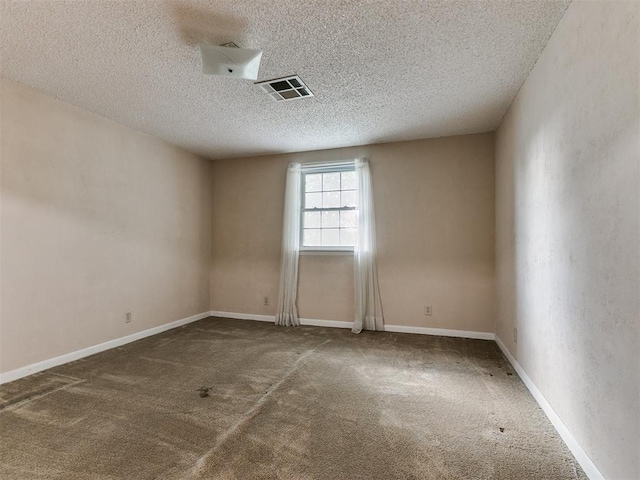 spare room featuring carpet floors and a textured ceiling