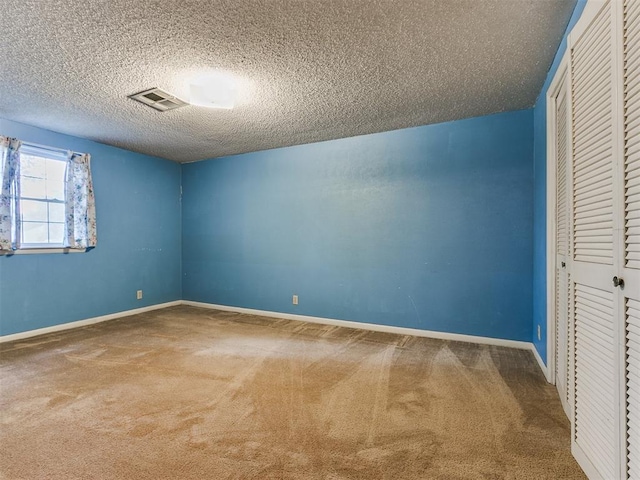 unfurnished bedroom featuring carpet and a textured ceiling