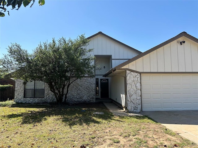 view of front of home with a front yard and a garage