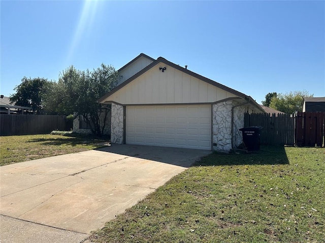 view of home's exterior with a garage and a lawn