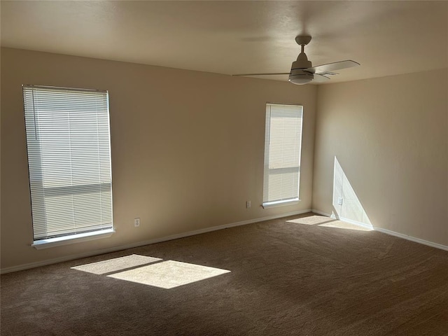 carpeted empty room featuring ceiling fan and a healthy amount of sunlight