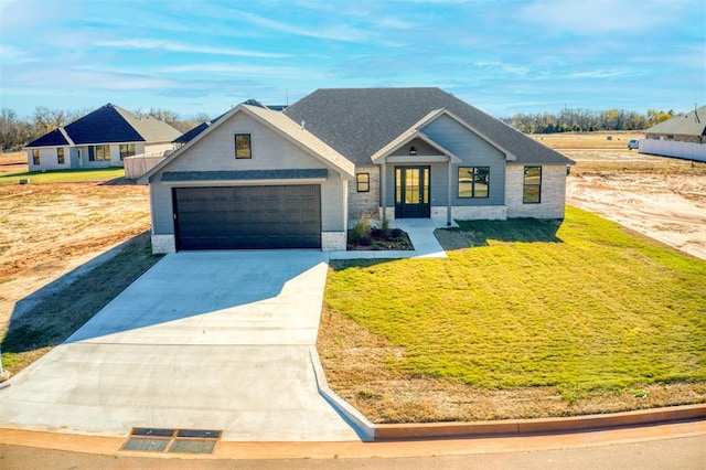 view of front of property with a garage and a front lawn