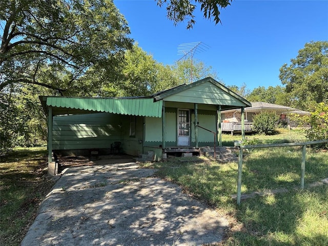 view of front facade with a porch and a carport