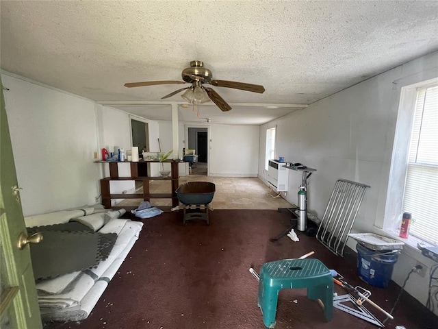 miscellaneous room with a textured ceiling, carpet floors, and ceiling fan