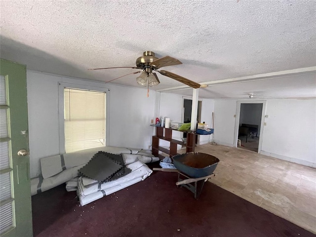 living room featuring a textured ceiling and ceiling fan