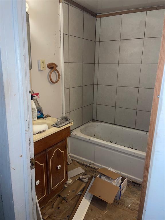 bathroom with vanity and a tub to relax in