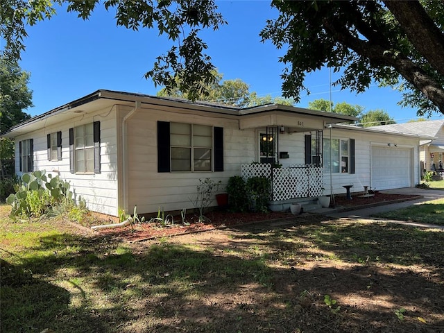 ranch-style house with a porch, a front yard, and a garage