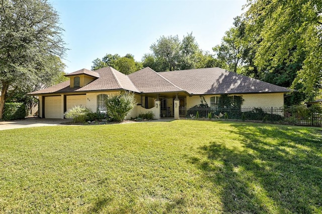 ranch-style house featuring a front yard and a garage