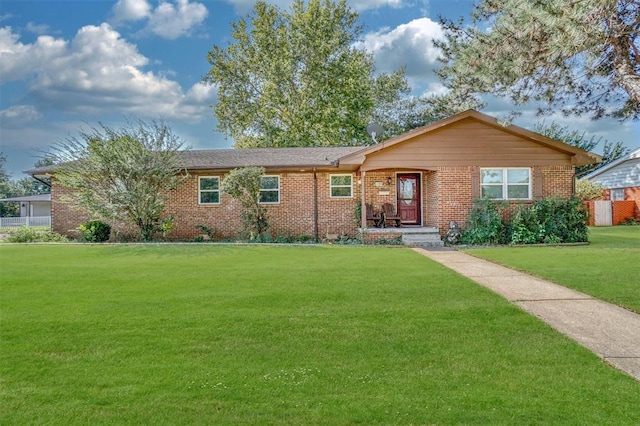 ranch-style house featuring a front yard