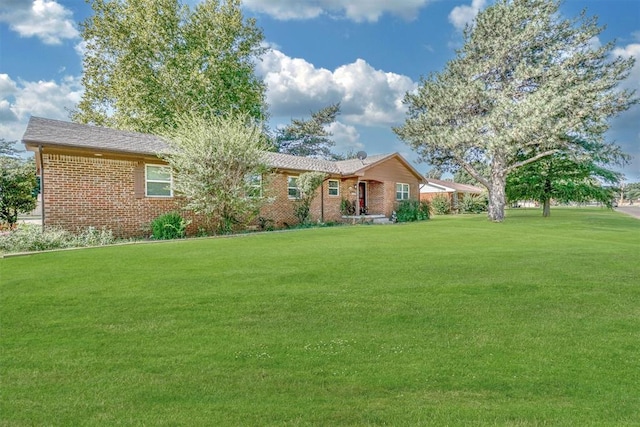 ranch-style home featuring a front yard