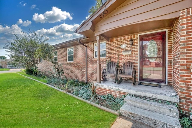 property entrance with a lawn