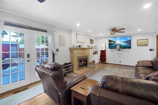 living room with ceiling fan, light hardwood / wood-style flooring, and ornamental molding