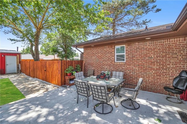 view of patio featuring a shed