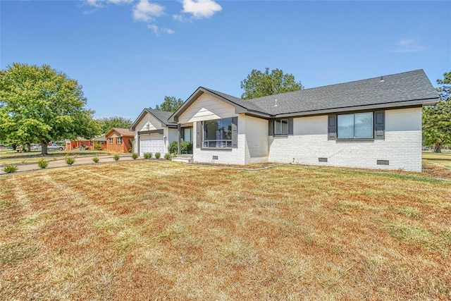 ranch-style house featuring a garage and a front lawn