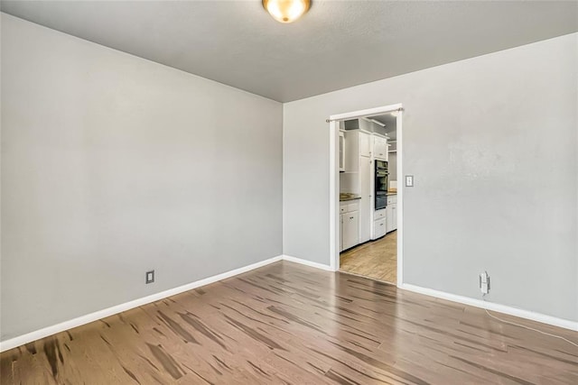 unfurnished room featuring light hardwood / wood-style flooring