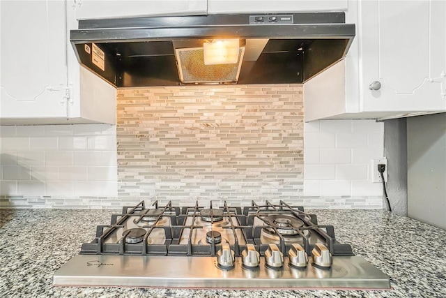 room details with white cabinets, backsplash, ventilation hood, and stainless steel gas cooktop