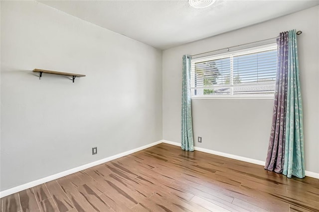 unfurnished room with hardwood / wood-style floors