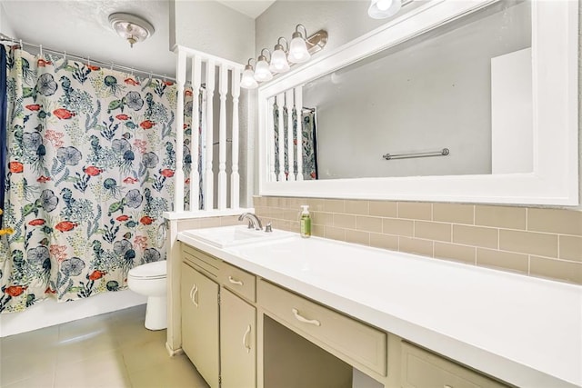 bathroom with backsplash, tile patterned floors, vanity, and toilet